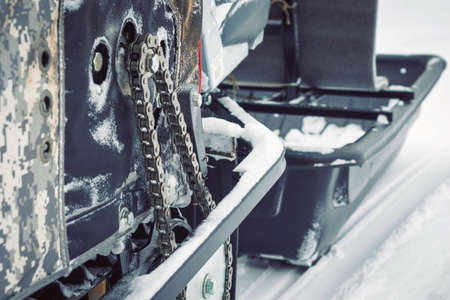 Background with a motorized winter vehicle on the snow close-up. Winter extreme travelの写真素材