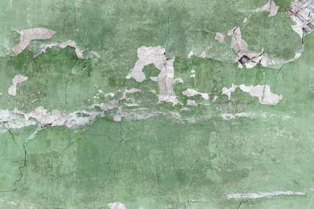 Background wall texture with old cracked green plaster.の写真素材