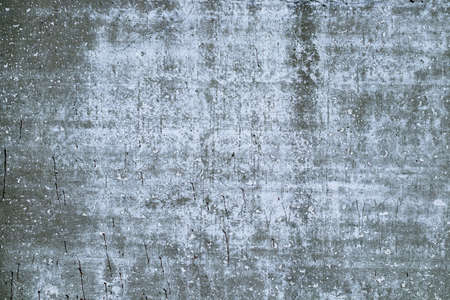 Background texture of an old gray concrete wall. Traces of old white paint.の写真素材