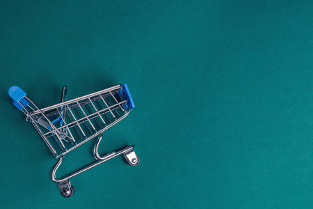 Grocery cart isolated on a green background. Sales conceptの写真素材