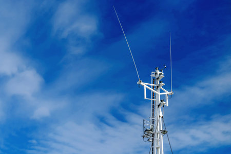 Mast of a sea vessel with navigation equipment on a background of blue sky. Cruiseの写真素材