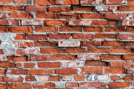 Background texture of an old brick wall with traces of plaster. Destroyed building wallの写真素材
