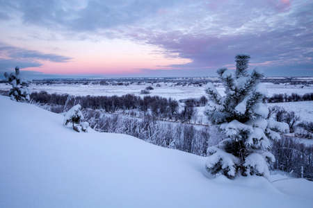 Sunrise over the snow-covered hillside. Winter landscapesの写真素材