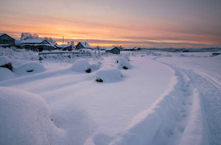 Winter landscape with a trail winding along the village in the snow. Walkingの写真素材