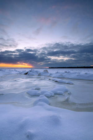 Beautiful winter sunset over the frozen river.の写真素材