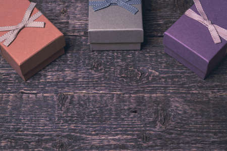 Background with vintage gift boxes with ribbon on the texture of the old wood.の写真素材