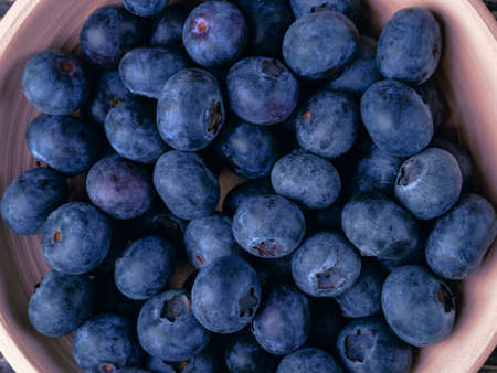Background with blueberries in a clay bowl.の写真素材