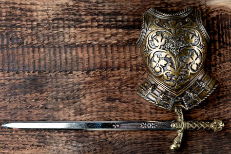 Armor of a medieval knight on the background of the texture of old wood.の写真素材