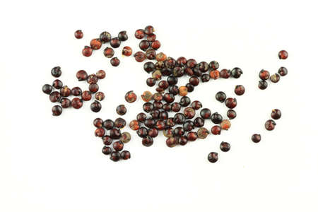 Macro photo of a few Harvested seeds of Organic Black Quinoa over white background close-up. Quinoa...