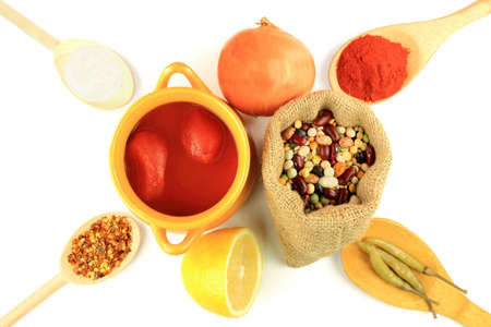 Cooking mix beans soup, beans in burlap bag, canned tomatoes in bowl, ingredients, seasonings in wooden spoons - red and crushed hot red paprika, Onion, Lemon, Sea Salt, hot jalapeno pickled pepper  の写真素材