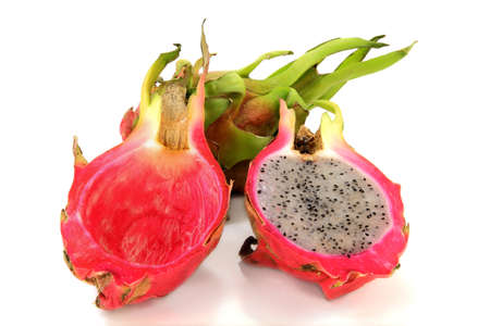 Entire and cut on half Pitaya  View of cut ripe Pitaya fruit  Pitahaya, Dragon Fruit  seen are internal eatable part  flesh  with seeds and processed,  cleaned  shell over white background の写真素材