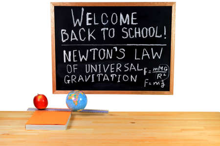 Black Chalkboard, written congratulation for Back to School, thematic of the Physics Class, visualization of the Newton Law with an apple, Globe toy and ruler in combination with the text book   の写真素材