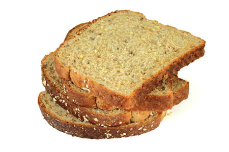 Slices of whole grains bread on vertical pile over white background  の写真素材