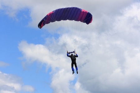 WATERDOWN, ONTARIO CANADA - AUGUST 2013  Skydiver after opening of the parachute on the way to the...