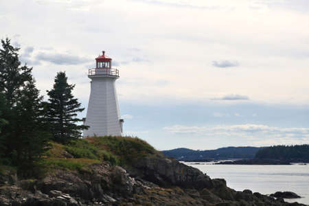 The lightstation (light house now museum) at Greenï¿½s Point, is octagonal wooden tower established in 1879 and altered in 1903 to direct boats and ships traffic trough LEtete Passage Bay of Fundyのeditorial素材