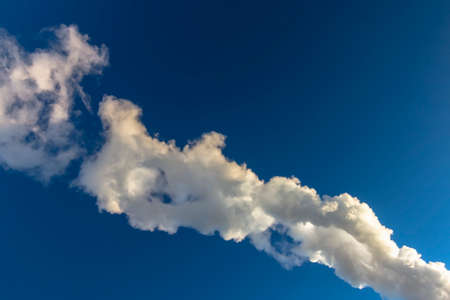 clouds of smoke and vapor in blue skyの写真素材