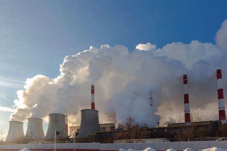 power plant emitting smoke and vapor in cold weather,の写真素材