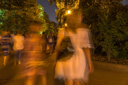 Walking among crowd of people along the parkway  on a warm summer's day.の写真素材