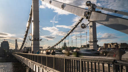 Silhouettes of people and cars on the steel bridgeの写真素材