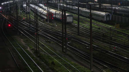 night movement of trains on a railway junction in moon lightの写真素材