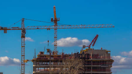 Cranes working on construction of the housing estate in former industrial zone.