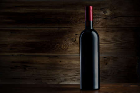 bottle of wine on a wooden backgroundの写真素材