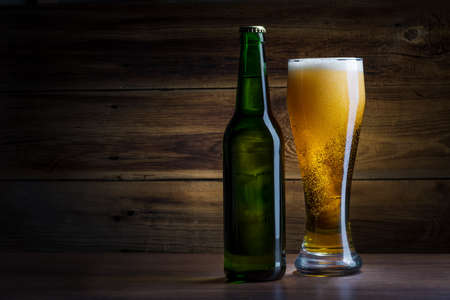 bottle of beer on a wooden background