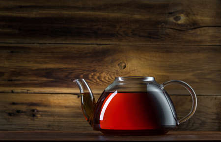 glass teapot on a wooden backgroundの写真素材