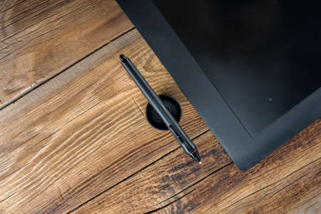 Graphics tablet Pen&Touch on a wooden backgroundの写真素材