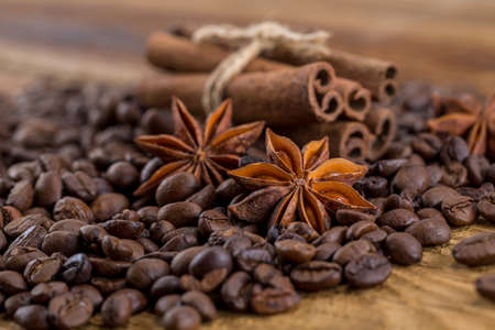 Coffee grains, anise and canella on old planksの写真素材