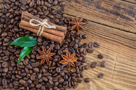 Coffee grains, anise and canella on old planksの写真素材