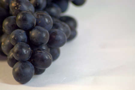 A bunch of red ripe grapes. The picture was taken in the lightbox, close-up.