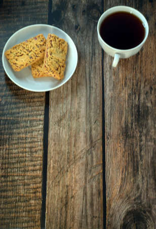 A cup of black tea on a porcelain plate. Close-up.の写真素材