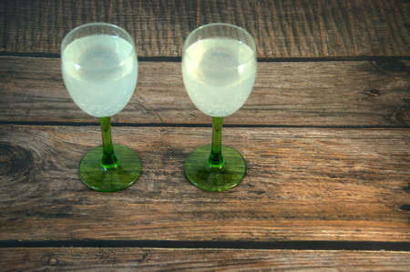 Two glasses of champagne on a wooden table. Close-up.の写真素材