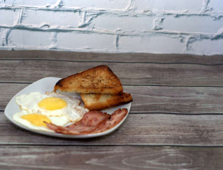 Two buds of pink and yellow flowers lie on a marble slab.の写真素材