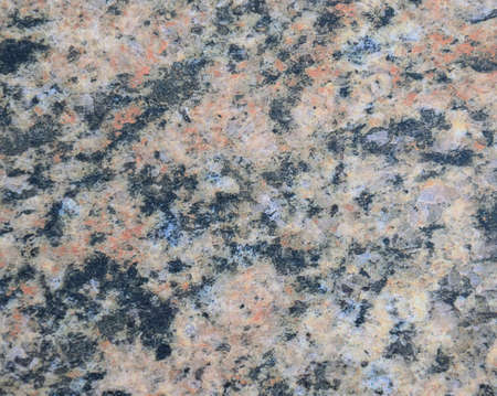 Dark granite, black-brown pattern of natural stone on a polished surface. Background.