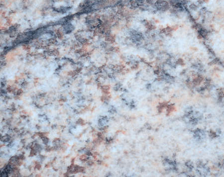 Natural stone marble light with brown and blue blotches. Close-up.
