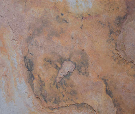 A fragment of a natural stone of gray color with traces of erosion close-up. Background, texture.