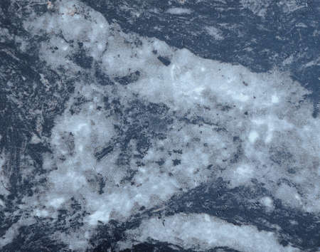 Natural black marble with a touch of white, polished stone surface close-up. Background, texture.