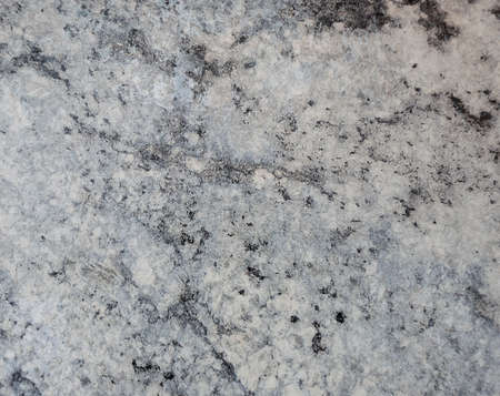 Close-up of gray marble interspersed with white and black veins. Background, texture.