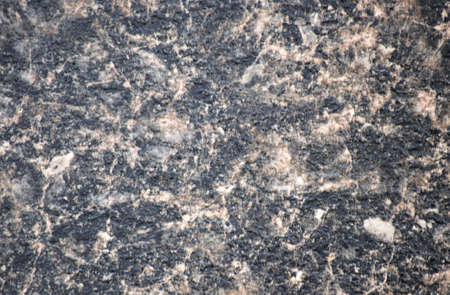 Black marble, natural stone surface with pale pink veins. Background, pattern, texture.
