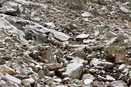 Huge stone boulders covered with the first snow on a cloudy autumn day. Altai, Siberia, Russia.の写真素材