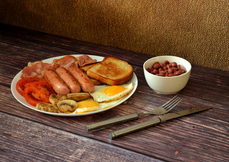 English breakfast, a plate with scrambled eggs, fried bacon, sissies, tomatoes, mushrooms and wheat...