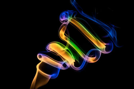 Coloured smoke on black backgroundの写真素材