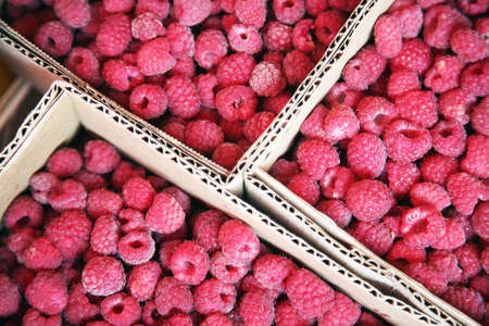 raspberries in a cardboard box on the store shelfの写真素材
