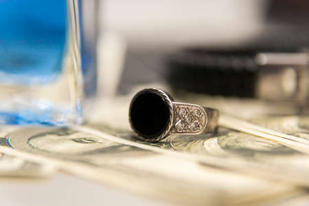 Silver ring, perfume, dollars and computerの写真素材