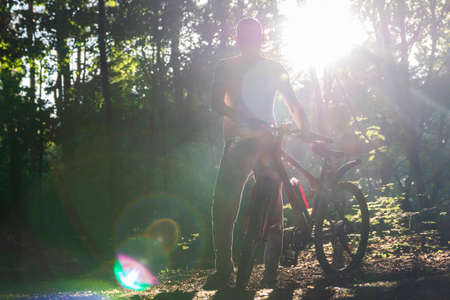 A sport bike in the spring green forest in the rays of sunlightのeditorial素材