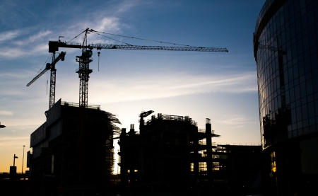 Construction site with cranes on sky background