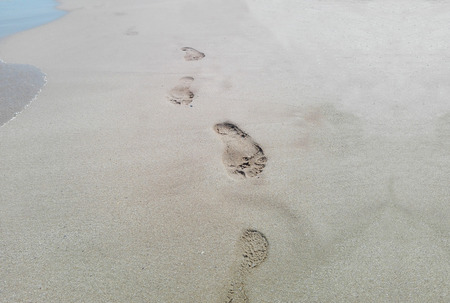 Detail of footprints on the sand and seaのeditorial素材