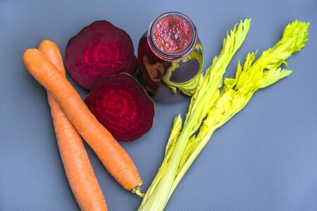 Glass jars mug with fresh and detox vegetables juice photo Carrot and Beet juiceの写真素材